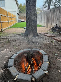 Outdoor fire pit at Duplex Dynasty short-term rental property in Texas